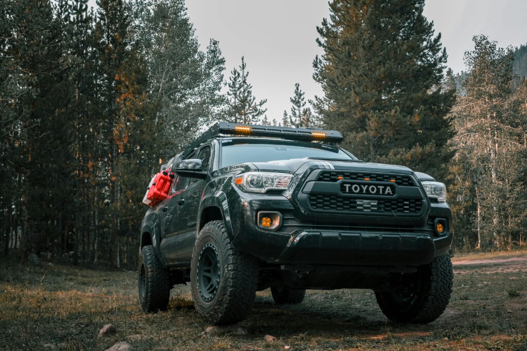 Powerful Toyota truck ready for an off-road adventure in a woodland setting.